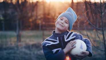 Happy boy holding his football